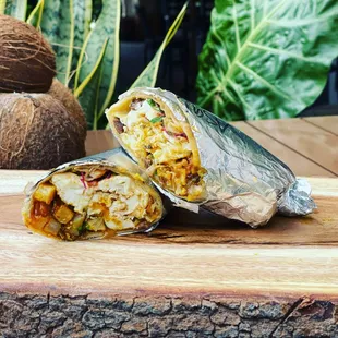 a burrito cut in half on a cutting board
