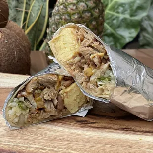 a burrito cut in half on a cutting board