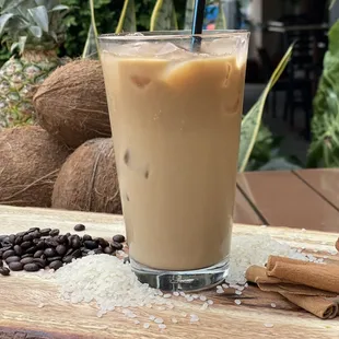a glass of iced coffee on a table