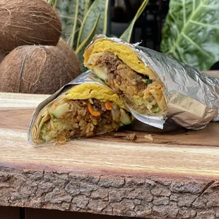 a burrito cut in half on a cutting board