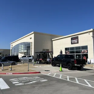 Outside (it's attached to the car dealership)