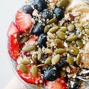 a hand holding a bowl of food