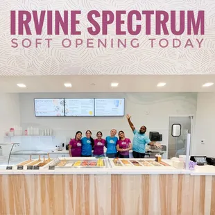 a group of people standing behind a counter