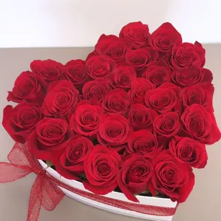 beautiful red roses in a white heart box