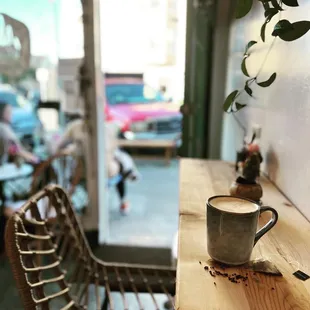 a cup of coffee on a wooden table