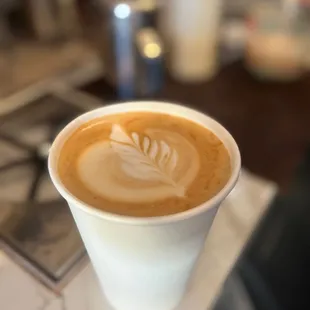 a latte in a paper cup