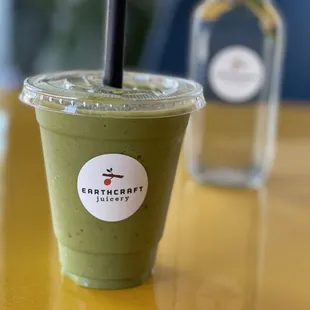 a green smoothie with a straw