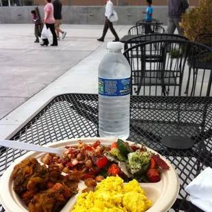 a plate of food and a bottle of water
