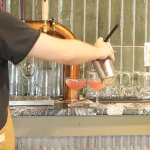 a bartender pouring a drink