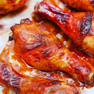 a close up of a tray of baked chicken legs