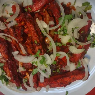 a plate of meat and onions