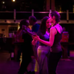 a couple dancing in a dance studio
