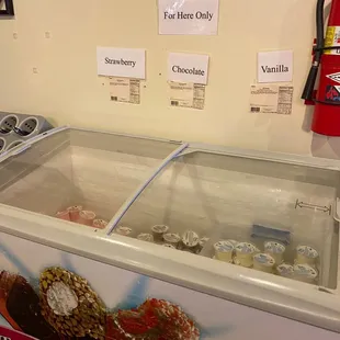 an ice cream counter with a variety of pastries