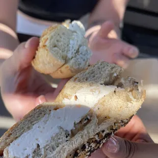 top: asiago bagel toasted w/ regular spread bottom: whole wheat everything bagel toasted w/ lox spread