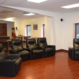 A comfortable lounge with theater seating and a large 82" television for your entertainment and comfort.