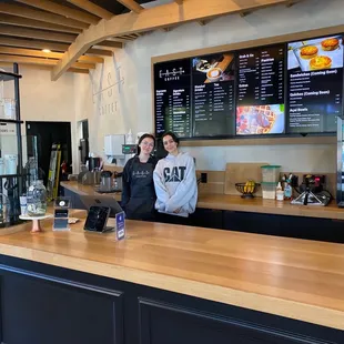 two people standing at the counter