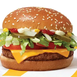 a cheeseburger with lettuce and tomatoes