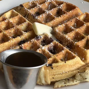 a waffle with butter and syrup