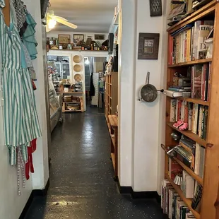 a narrow hallway with bookshelves