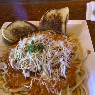 a plate of spaghetti and bread