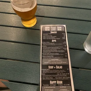 a menu and a glass of beer