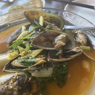 75. Cooked Mussels in Cilantro and Wine Broth.