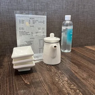 a table with a menu and a bottle of water