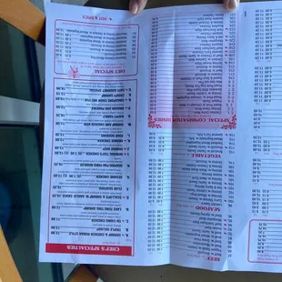 a person holding a menu