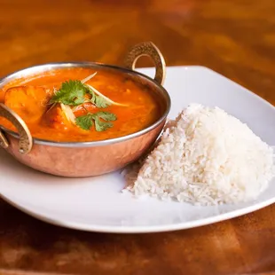 TIKKA MASALA A timeless favorite which consists of a rich creamy tomato, onion, and coriander gravy served with Tandoori protein.