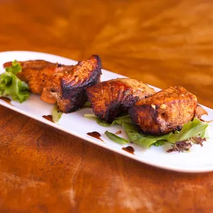 MACHLI KA TIKKA (GF) Salmon cooked in a roasted garlic, mustard, curry, fresh ginger marinade