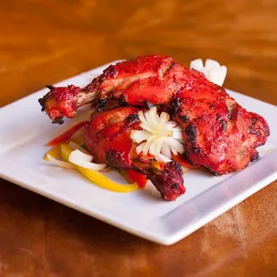TANDOORI CHICKEN (GF)
bone in chicken marinated in thick yogurt, spices &amp; Kashmiri cayenne