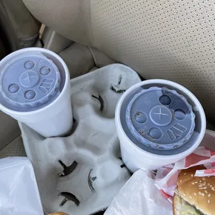 two cups of soda and a hamburger