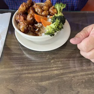 a person sitting at a table with a bowl of food