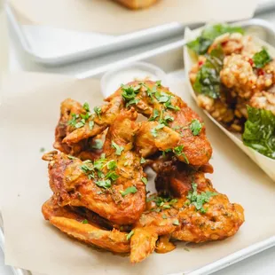 a plate of wings and a bowl of rice