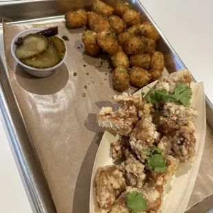 Sinigang boneless bites with furikake tots and pickles