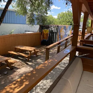 a patio with benches and tables