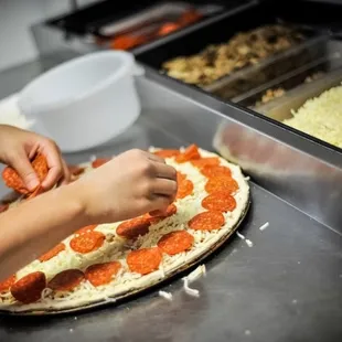 a person making a pizza