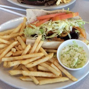 Skirt steak sandwich with coleslaw.