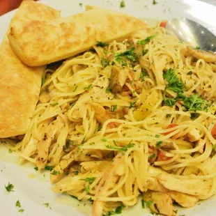 Garlic Chicken - Thin spaghetti and grilled chicken with mushrooms, artichokes, onions, and tomatoes with garlic butter sauce