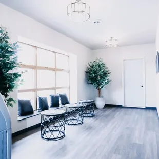 a living room with white walls and wood floors