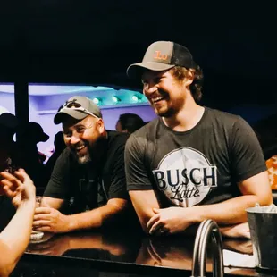 a group of men sitting at a bar