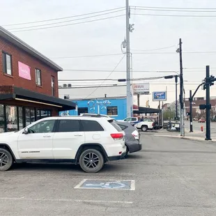 a white jeep parked in a parking lot