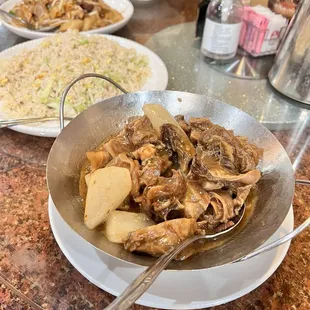 a bowl of stew and a plate of rice