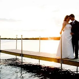 a bride and groom on a dock
