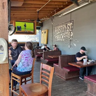 people sitting at tables in a restaurant
