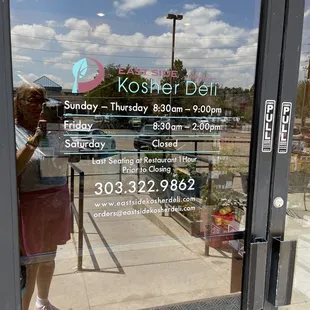 a woman standing in front of the door