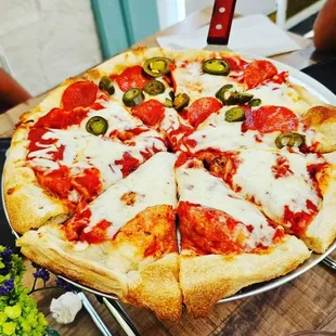 a pizza with pepperoni and olives
