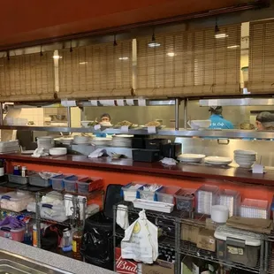 a kitchen with a lot of dishes on the counter