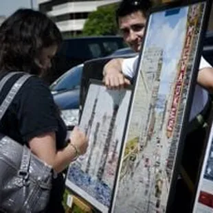a man and woman looking at art