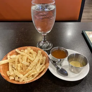 a plate of french fries and a glass of water